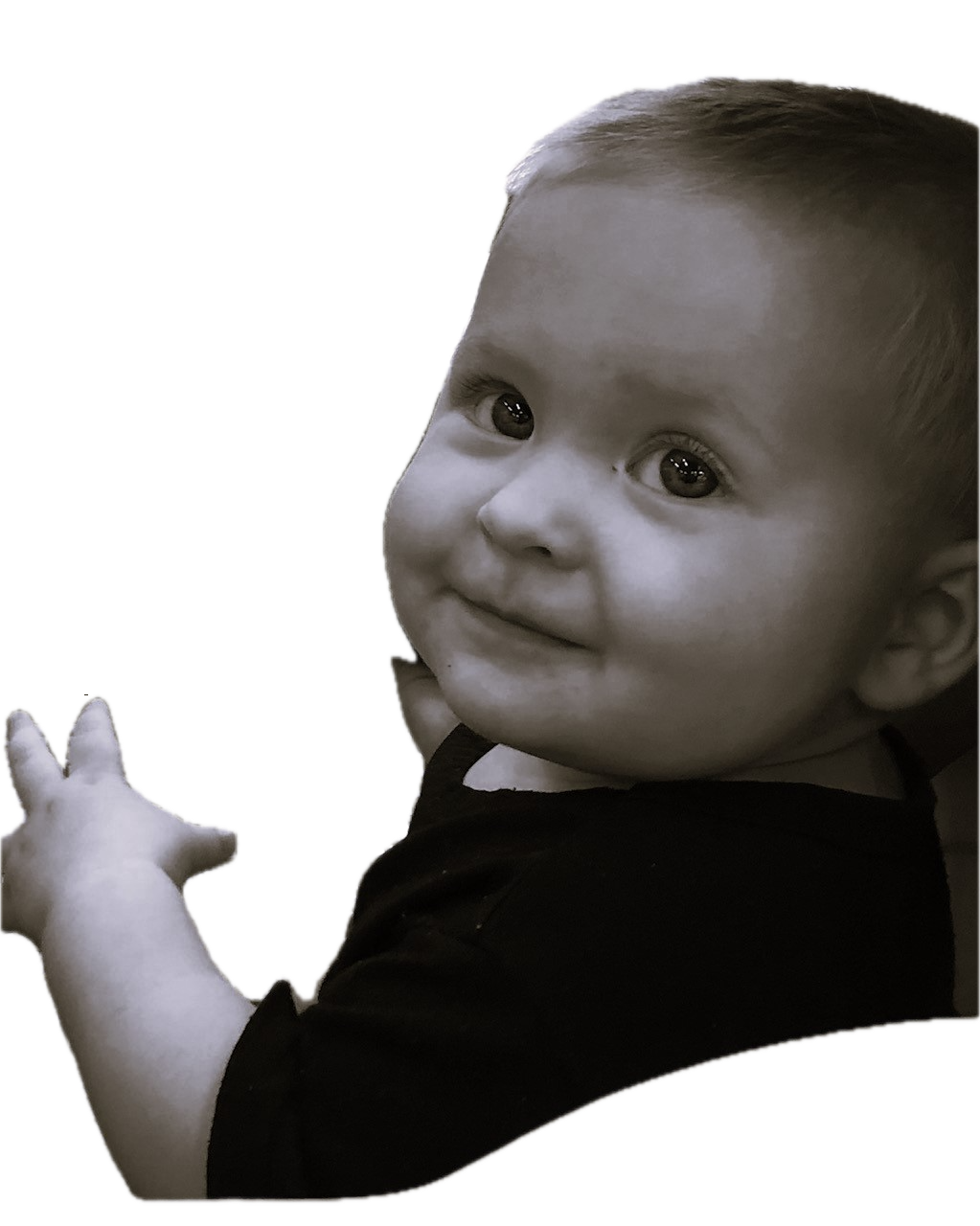 Smiling baby with dark background, black shirt.