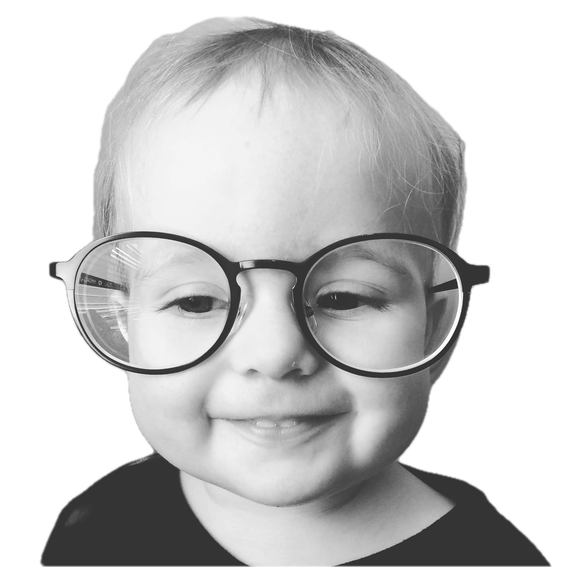 Baby wearing large round glasses, smiling.